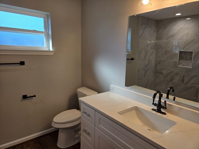 1403 Hitherfield Dr, Sugar Land, TX 77498 - bathroom featuring toilet, vanity, wood finished floors, and baseboards