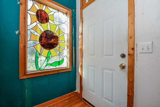 entrance foyer featuring baseboards and wood finished floors