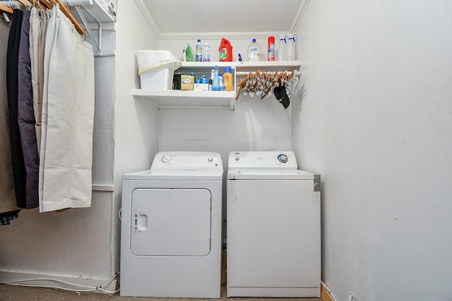 clothes washing area with washing machine and dryer, ornamental molding, and laundry area