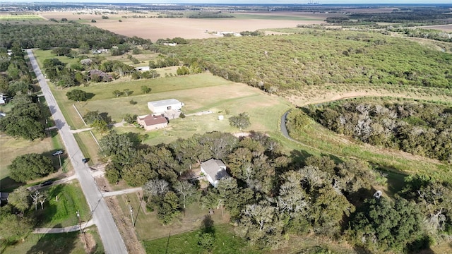birds eye view of property with a rural view