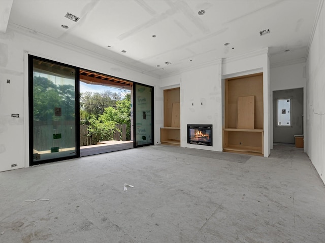 unfurnished living room featuring ornamental molding and a glass covered fireplace