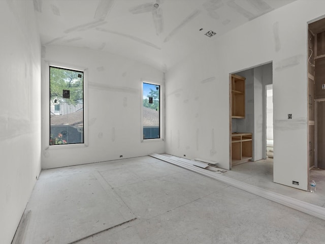 unfurnished room featuring lofted ceiling