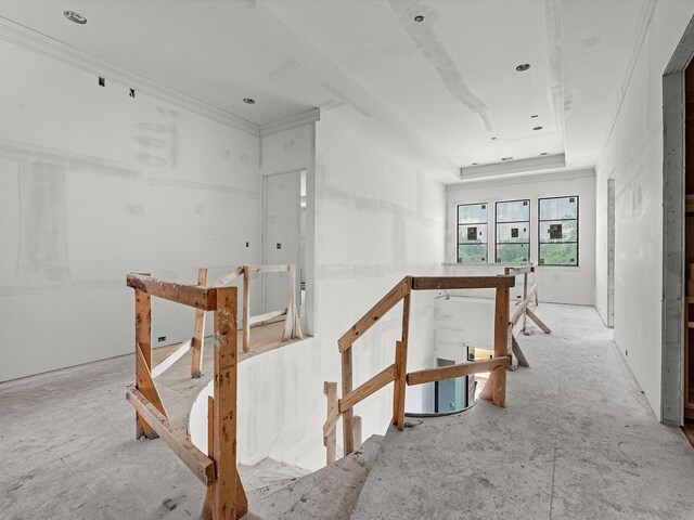 hall with crown molding and an upstairs landing