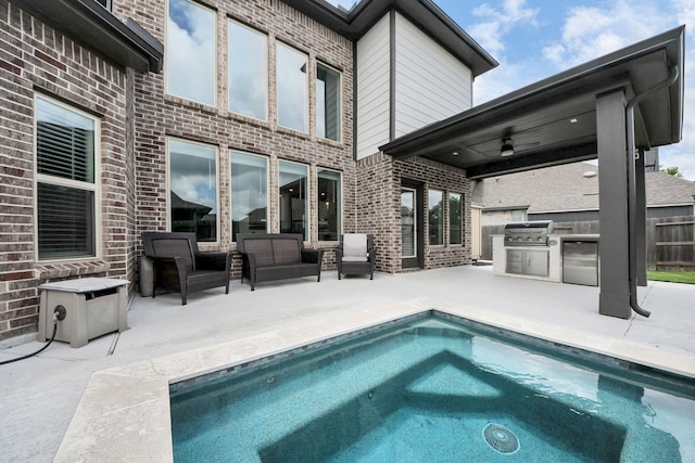 30706 Thicket Ct, Fulshear, TX 77441 - back of property featuring brick siding, an outdoor kitchen, and a patio