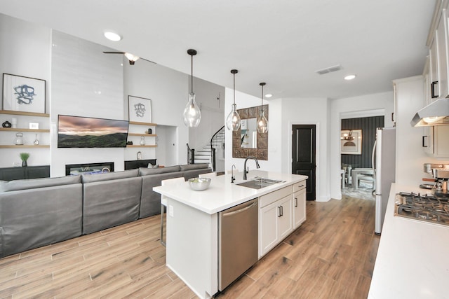30706 Thicket Ct, Fulshear, TX 77441 - kitchen featuring white cabinets, light countertops, visible vents, a sink, and appliances with stainless steel finishes