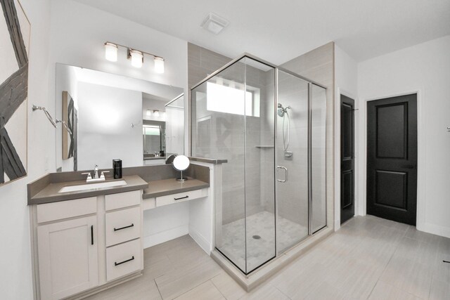 30706 Thicket Ct, Fulshear, TX 77441 - bathroom with baseboards, vanity, and a stall shower