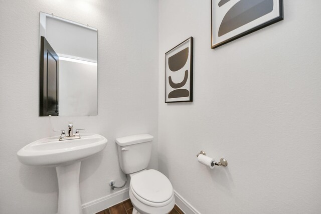 30706 Thicket Ct, Fulshear, TX 77441 - bathroom featuring wood finished floors, baseboards, and toilet