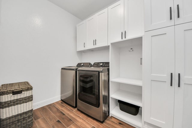 30706 Thicket Ct, Fulshear, TX 77441 - clothes washing area featuring baseboards, cabinet space, dark wood-style floors, and independent washer and dryer