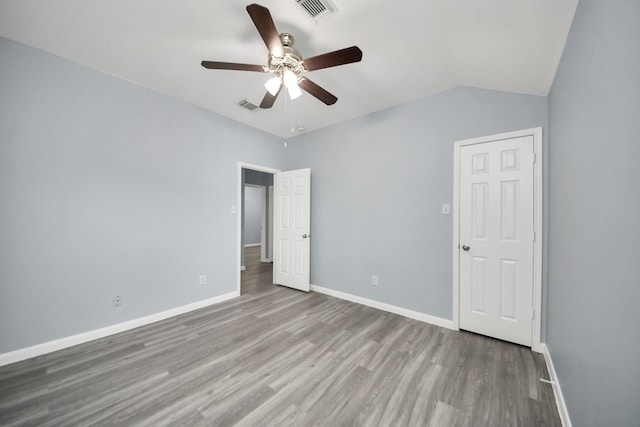 unfurnished bedroom featuring baseboards, wood finished floors, and visible vents
