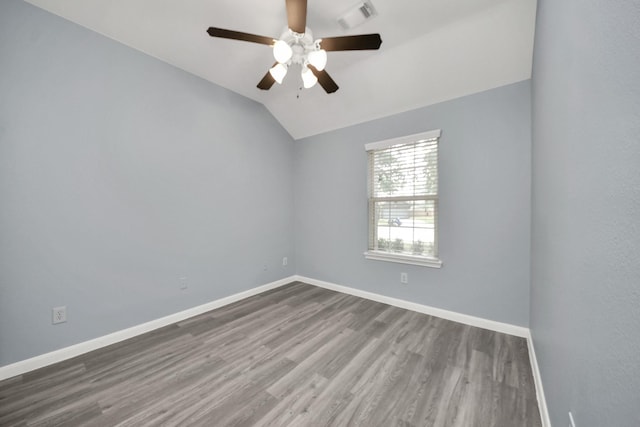 spare room featuring wood finished floors, visible vents, a ceiling fan, and baseboards