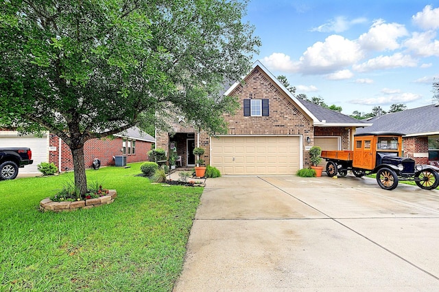 16611 River Wood Ct, Crosby, TX 77532 - traditional-style home featuring a front yard, cooling unit, driveway, brick siding, and an attached garage