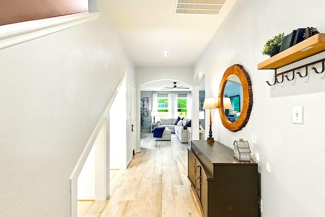 16611 River Wood Ct, Crosby, TX 77532 - corridor featuring visible vents, arched walkways, light wood-style flooring, and a textured wall