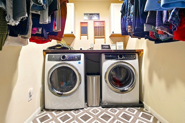 16611 River Wood Ct, Crosby, TX 77532 - clothes washing area with tile patterned floors, baseboards, cabinet space, and washing machine and dryer