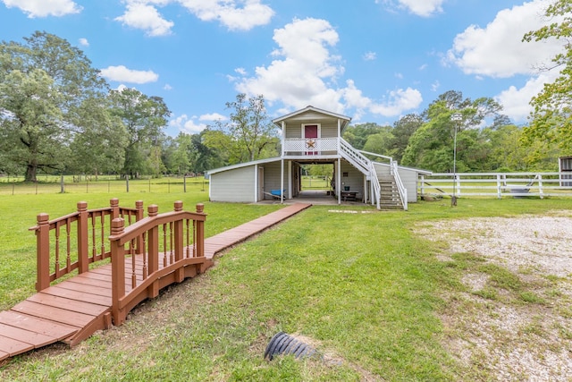 view of yard featuring fence, stairway, and a deck