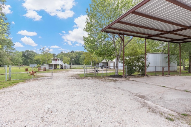 exterior space with an outbuilding, fence, and a gate