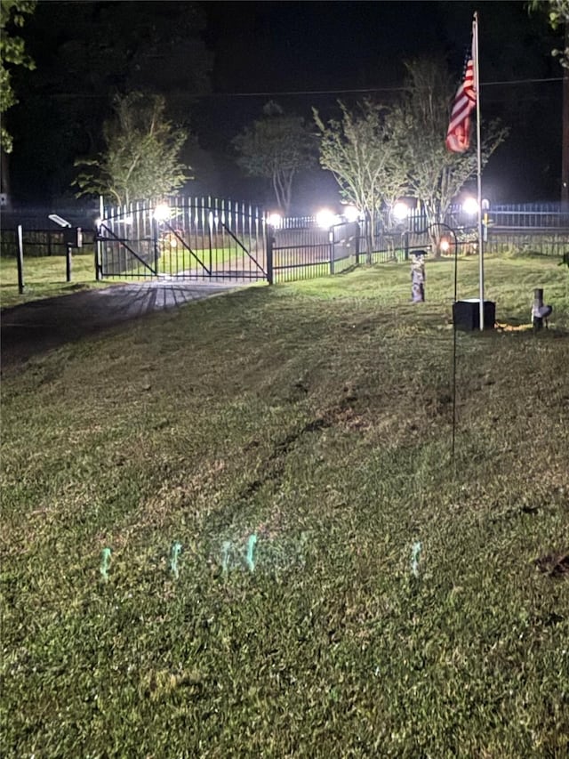 yard at twilight featuring fence