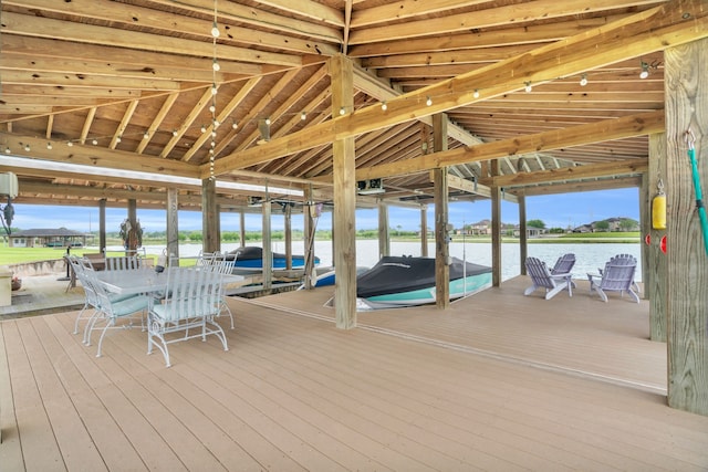 exterior space featuring a water view, a dock, and boat lift