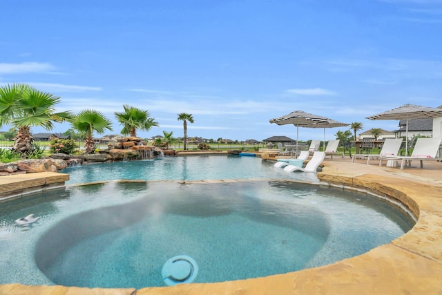 view of pool featuring a pool with connected hot tub