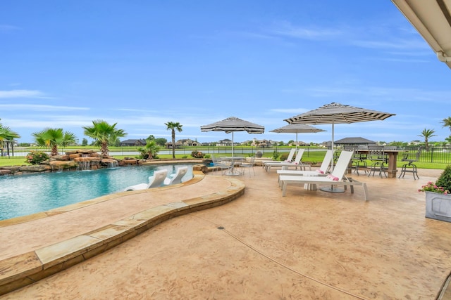 pool featuring a patio and fence