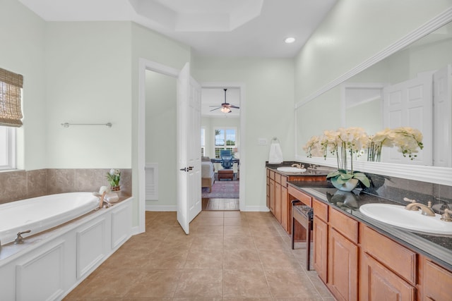 full bath with a sink, a bath, tile patterned floors, a ceiling fan, and double vanity