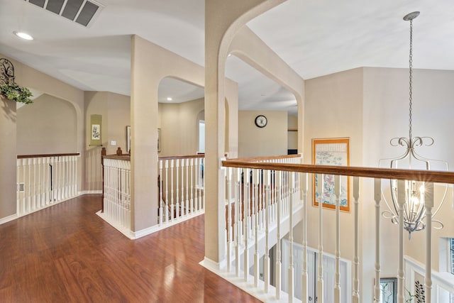 3719 Arundel Gardens Ln, Sugar Land, TX 77498 - hallway with a chandelier, an upstairs landing, wood finished floors, baseboards, and arched walkways