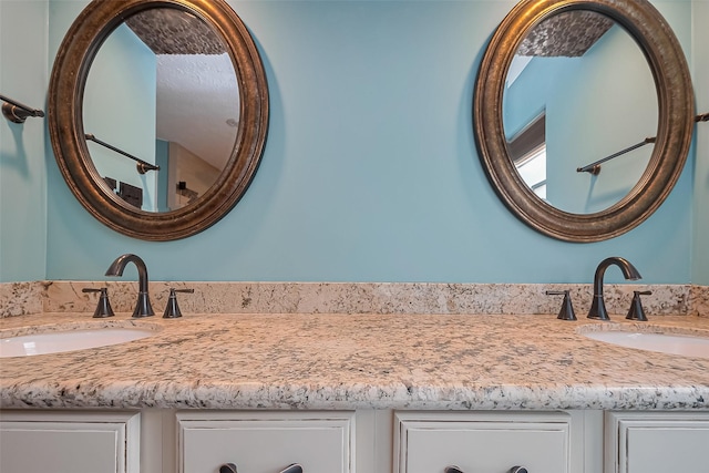 bathroom featuring double vanity and a sink