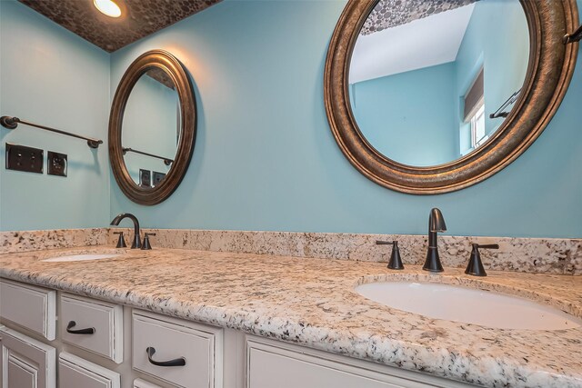 full bath with recessed lighting, double vanity, and a sink