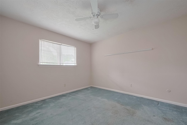 carpeted empty room featuring a textured ceiling, a ceiling fan, and baseboards