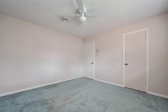 unfurnished bedroom with baseboards, visible vents, a textured ceiling, and carpet flooring