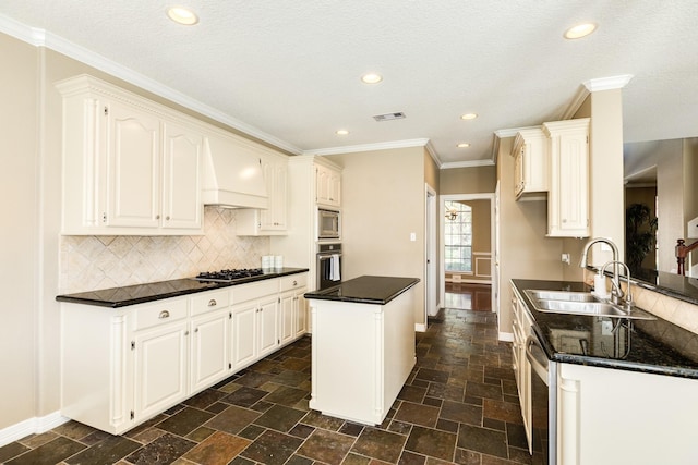 51 Scotch Pine Ct, Lake Jackson, TX 77566 - kitchen with dark countertops, a sink, stainless steel appliances, and visible vents
