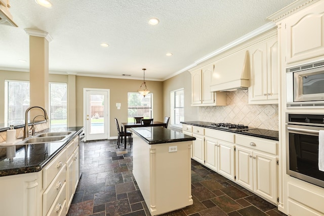 51 Scotch Pine Ct, Lake Jackson, TX 77566 - kitchen featuring a sink, premium range hood, a kitchen island, ornamental molding, and appliances with stainless steel finishes