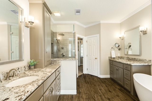 51 Scotch Pine Ct, Lake Jackson, TX 77566 - bathroom featuring a sink, a shower stall, wood finished floors, and visible vents