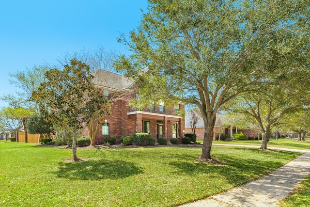 51 Scotch Pine Ct, Lake Jackson, TX 77566 - traditional home featuring brick siding and a front yard