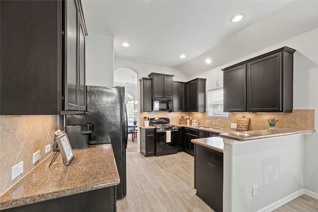 13215 Dover Bluff Dr, Rosharon, TX 77583 - kitchen with black appliances, arched walkways, backsplash, light wood-type flooring, and recessed lighting