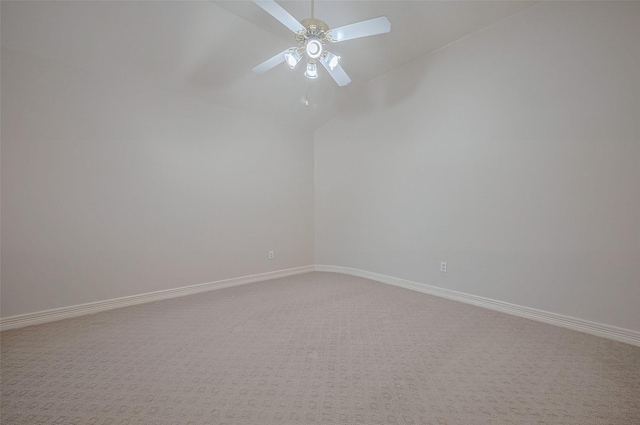 unfurnished room with light colored carpet, a ceiling fan, vaulted ceiling, and baseboards