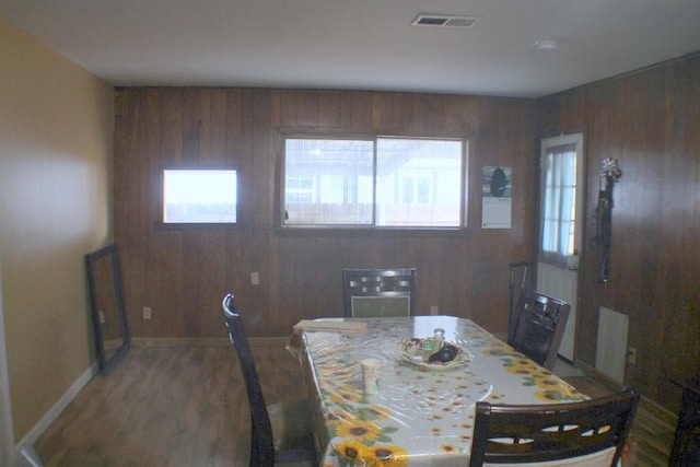 4334 Bell St, Houston, TX 77023 - dining space featuring healthy amount of natural light, wood walls, and wood finished floors
