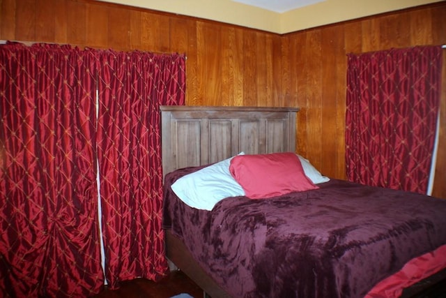 bedroom featuring wood walls