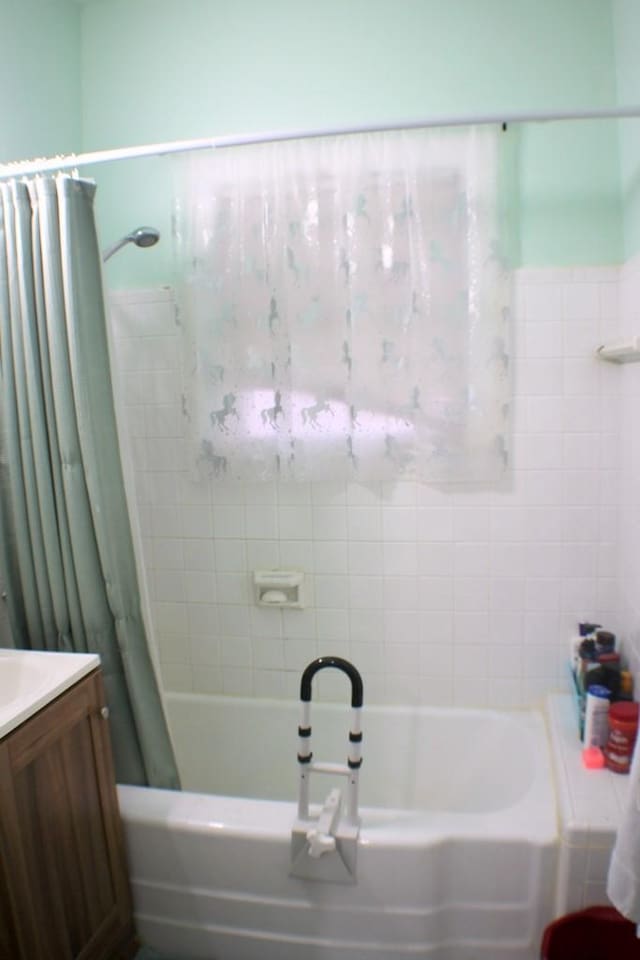 full bathroom featuring vanity and shower / bath combination with curtain