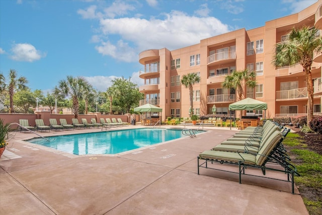 community pool with a patio area