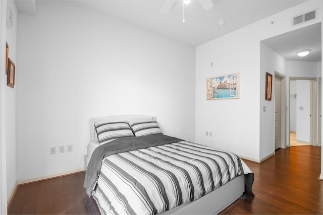 bedroom featuring baseboards, visible vents, wood finished floors, and ceiling fan