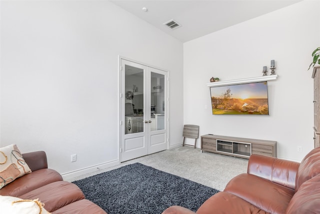 carpeted living room featuring visible vents and baseboards