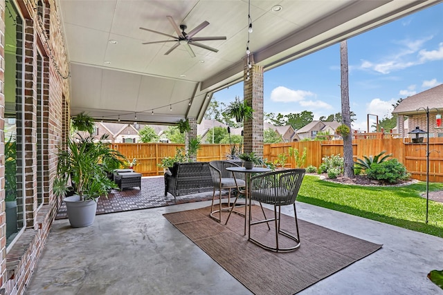 view of patio / terrace featuring a fenced backyard, a ceiling fan, and outdoor dining area