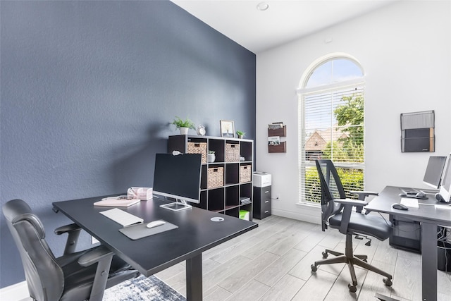 home office featuring light wood finished floors and baseboards