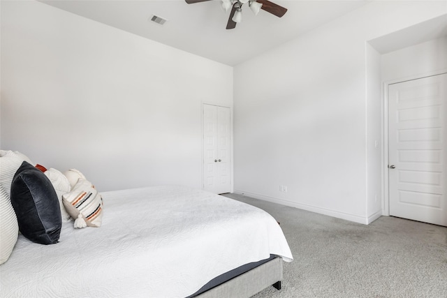 carpeted bedroom with visible vents, a ceiling fan, and baseboards