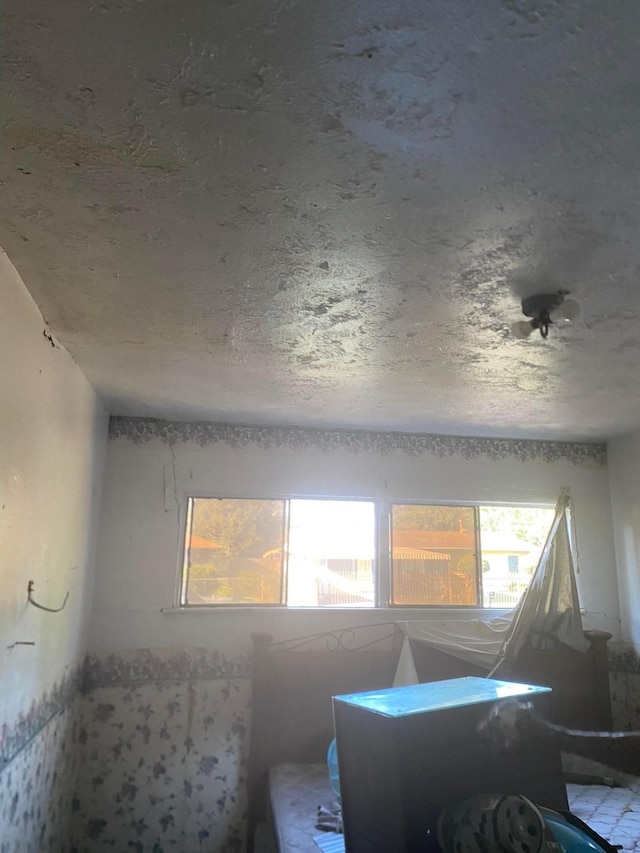 miscellaneous room with a textured ceiling