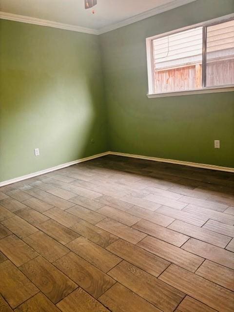 unfurnished room with baseboards, ornamental molding, and wood finished floors