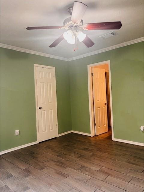 empty room featuring hardwood / wood-style flooring, ceiling fan, and crown molding