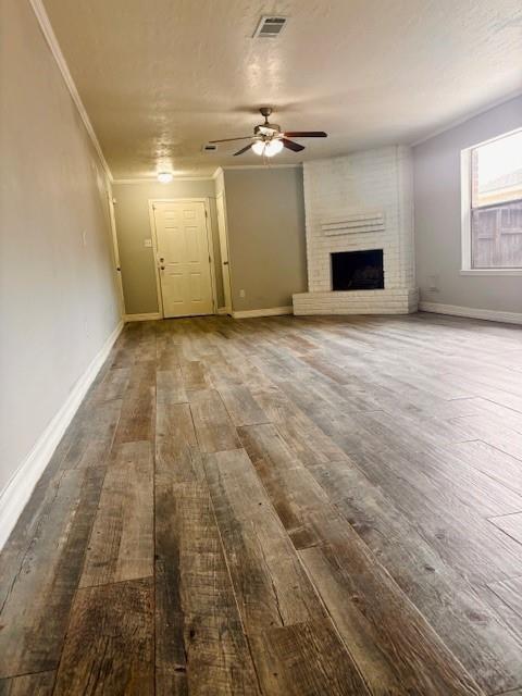 unfurnished living room with visible vents, ceiling fan, wood finished floors, and baseboards