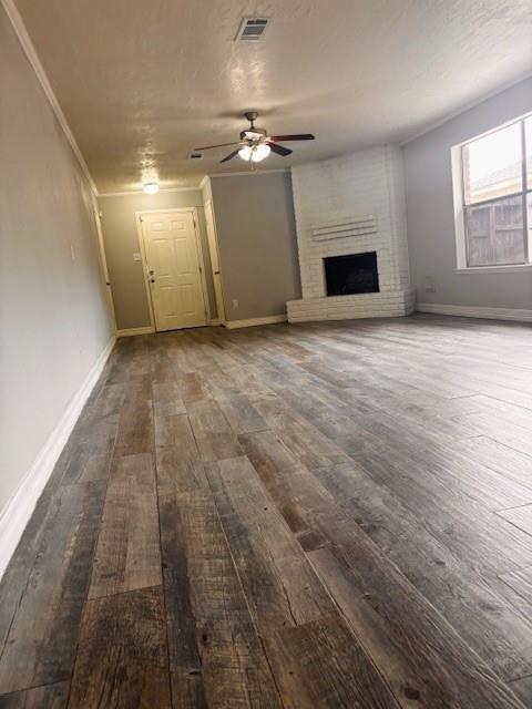 unfurnished living room with visible vents, ceiling fan, baseboards, and dark wood finished floors