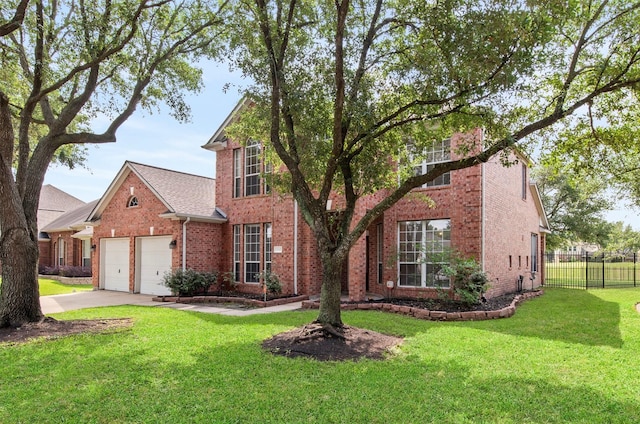 traditional home with a front lawn, a garage, driveway, brick siding, and fence